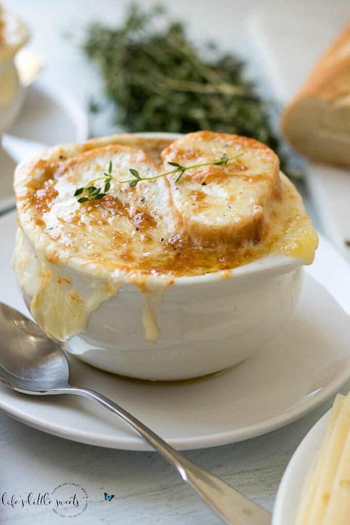 This Homemade French Onion Soup recipe has the flavors of a classic French onion soup that you would find at a restaurant, yet, it is easy to prepare in your home kitchen. Caramelized onions in a reduction of white wine and sherry with herbs of thyme and bay leaves in a clear beef broth make this soup delicious. #onions #Frenchonionsoup #cheese #recipe #Frenchbread #homemade #thyme #garlic #Muentser #Swiss