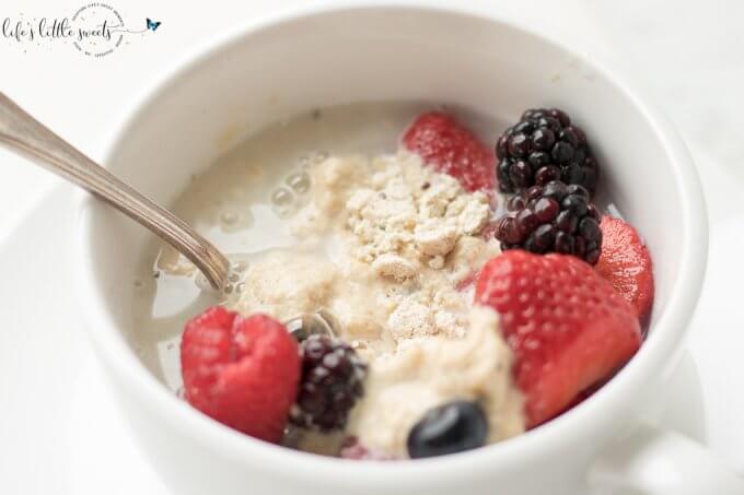 Easy Breakfast Mug Cake in white mug with berries and silver spoon 