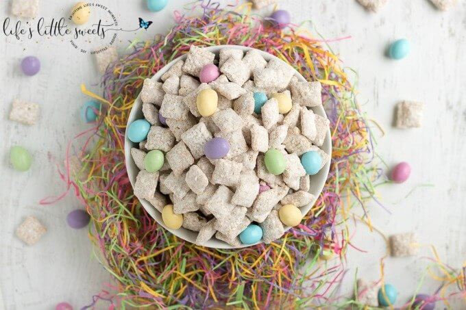This Easter Muddy Buddies Recipe are a sweet and salty dessert snack with cereal coated in white chocolate and peanut butter, customized with your favorite Easter-themed candies. Try this delicious snack at your next Easter or Springtime gathering! #Spring #recipe #chocolate #M&Ms #peanutm&ms #snack #candy #muddybuddies #puppychow #Chex #ricecereal #Easter