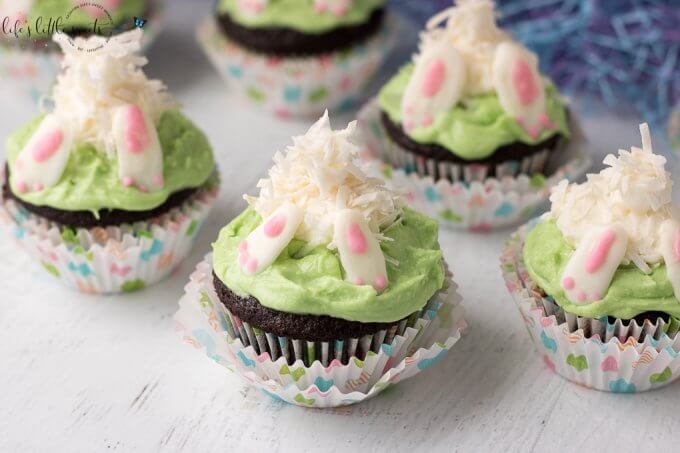 These Bunny Butt Cupcakes Recipe are the perfect Easter and Springtime-themed cupcakes for your next gathering! They have a delicious and moist chocolate cupcake base with a marshmallow and coconut flake bunny diving into buttercream 