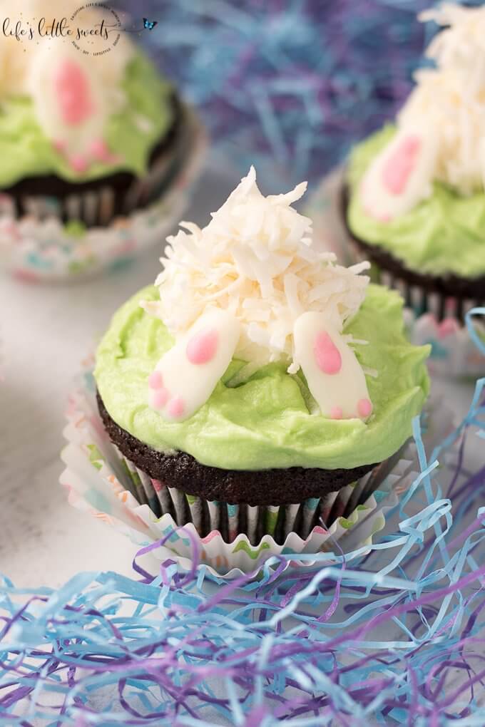 These Bunny Butt Cupcakes Recipe are the perfect Easter and Springtime-themed cupcakes for your next gathering! They have a delicious and moist chocolate cupcake base with a marshmallow and coconut flake bunny diving into buttercream 