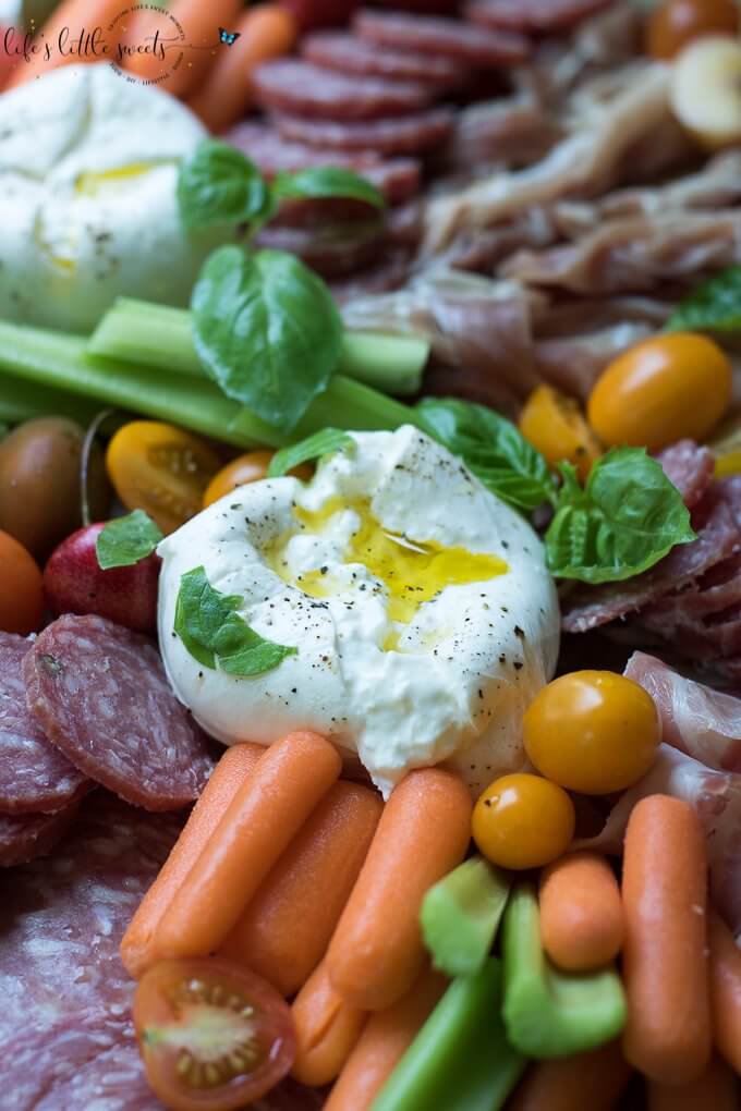 This Burrata Charcuterie Board comes together with Burrata (young Mozzarella) and Charcuterie meats. This appetizer board recipe is easy to put together for entertaining and pairs well with Dreaming Tree Crush, Sauvignon Blanc and Chardonnay wines. #ad @dreamingtreewines #SeedOfAGreatSummer #CollectiveBias #burrata #charcuterie #burrataboard #charcuterieboard #appetizer #veggies #hummus #basil #mozzarella