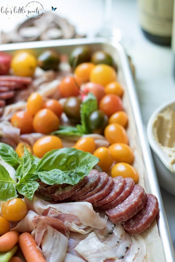 This Burrata Charcuterie Board comes together with Burrata (young Mozzarella) and Charcuterie meats. This appetizer board recipe is easy to put together for entertaining and pairs well with Dreaming Tree Crush, Sauvignon Blanc and Chardonnay wines. #ad @dreamingtreewines #SeedOfAGreatSummer #CollectiveBias #burrata #charcuterie #burrataboard #charcuterieboard #appetizer #veggies #hummus #basil #mozzarella