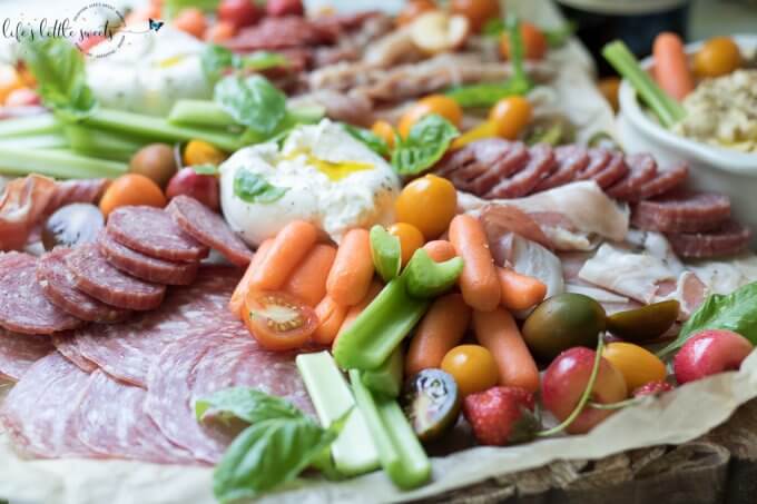 This Burrata Charcuterie Board comes together with Burrata (young Mozzarella) and Charcuterie meats. This appetizer board recipe is easy to put together for entertaining and pairs well with Dreaming Tree Crush, Sauvignon Blanc and Chardonnay wines. #ad @dreamingtreewines #SeedOfAGreatSummer #CollectiveBias #burrata #charcuterie #burrataboard #charcuterieboard #appetizer #veggies #hummus #basil #mozzarella