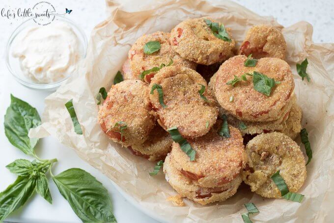 Gluten Free Fried Tomatoes are a delicious Summer appetizer or vegetarian side dish - juicy, ripe, red tomatoes with a gluten free flour, egg, milk and corn flour coating fried in Canola oil make for a crispy outer texture, sprinkle with fresh basil! #tomatoes #cornmeal #glutenfree #fried #canolaoil #appetizer #tomatoseason #friedtomatoes #basil