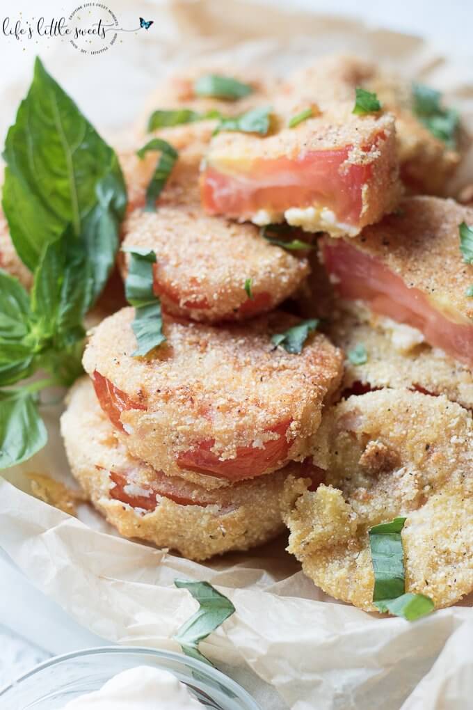 Gluten Free Fried Tomatoes are a delicious Summer appetizer or vegetarian side dish - juicy, ripe, red tomatoes with a gluten free flour, egg, milk and corn flour coating fried in Canola oil make for a crispy outer texture, sprinkle with fresh basil! #tomatoes #cornmeal #glutenfree #fried #canolaoil #appetizer #tomatoseason #friedtomatoes #basil