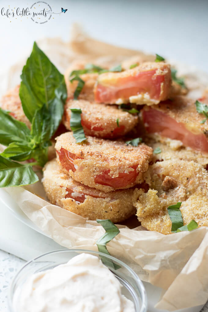 Gluten Free Fried Tomatoes are a delicious Summer appetizer or vegetarian side dish - juicy, ripe, red tomatoes with a gluten free flour, egg, milk and corn flour coating fried in Canola oil make for a crispy outer texture, sprinkle with fresh basil! #tomatoes #cornmeal #glutenfree #fried #canolaoil #appetizer #tomatoseason #friedtomatoes #basil