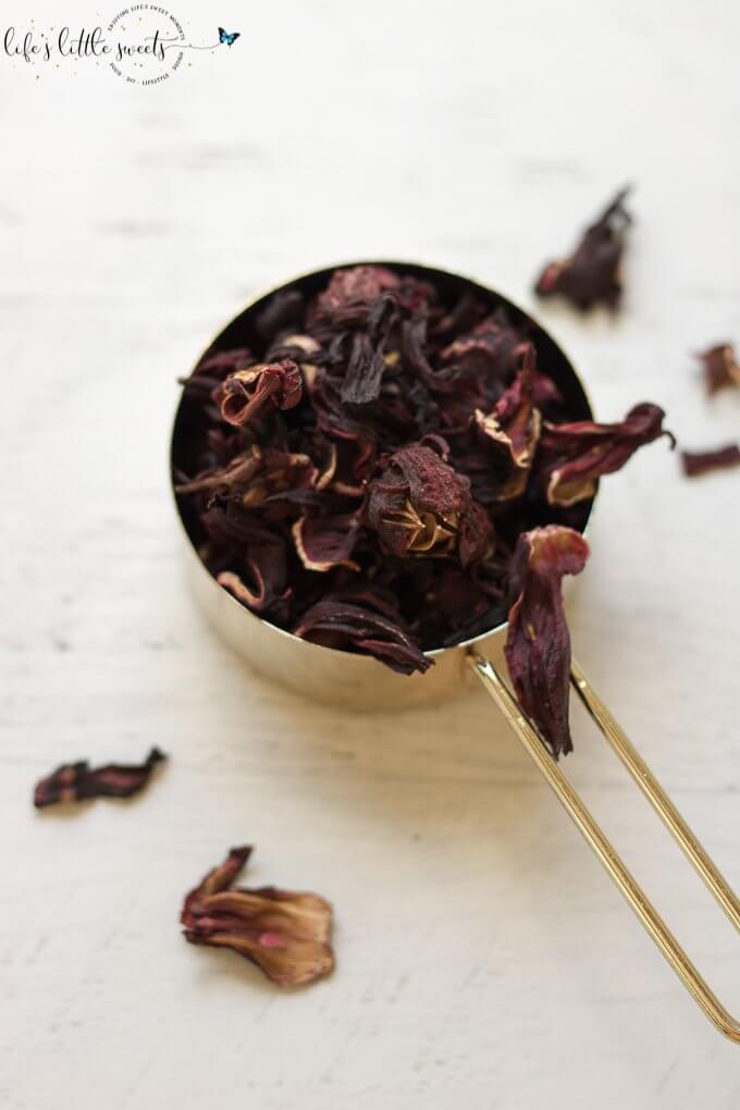 dried hibiscus in a gold measuring cup Hibiscus Tea Recipe