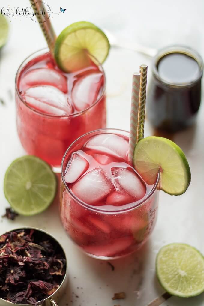 This Hibiscus Tea Recipe uses dried hibiscus flowers and can be served unsweetened or sweetened with honey or your favorite sweetener and garnished with lime slices. Enjoy the many health benefits of hibiscus with this lovely warm weather sipper! (vegan option, gluten-free) #vegan #glutenfree #healthy #hibiscustea #tea #driedhibiscus #hibsicus #lime #iced #honey #cold