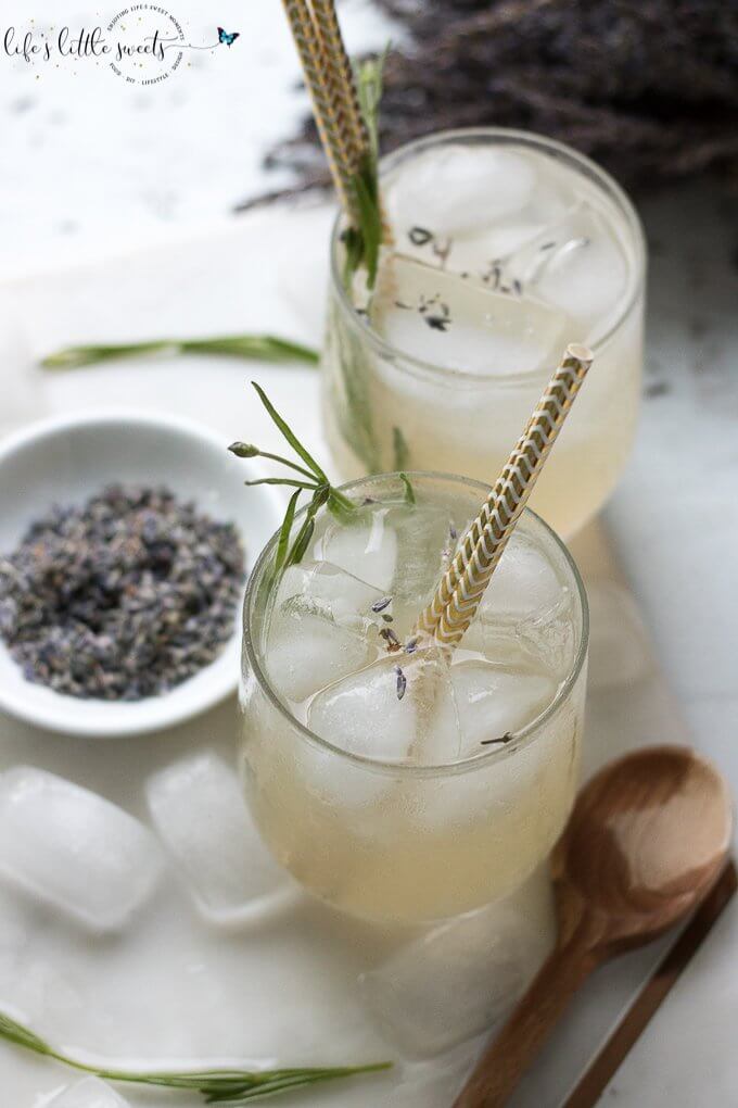 This Lavender Lemonade is made with freshly squeezed lemon juice then sweetened with a lavender-infused simple syrup. Garnish with food grade dried lavender flowers and a sprig of fresh lavender and you have yourself the ideal summer sipper! This recipe uses Lavender Simple Syrup. #lavender #lavenderlemonade #lemonade #driedlavender #iced #drink #colddrink #Summerdrink #vegan #glutenfree