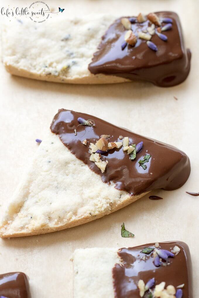 This Lavender Shortbread has fresh lavender, mint and lemon zest. Top with chopped nuts, like pecans, and dip in melted semi sweet chocolate, if you like. Welcome Summer with all it's fresh ingredients in this classic shortbread recipe. #lavender #mint #shortbread #freshlavender #lemon #lemonzest #pecans #cookies #chocolate #chocolatedipped