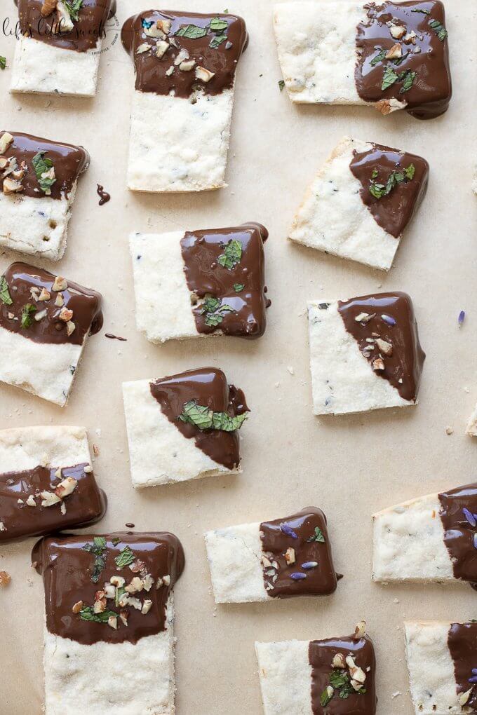 This Lavender Shortbread has fresh lavender, mint and lemon zest. Top with chopped nuts, like pecans, and dip in melted semi sweet chocolate, if you like. Welcome Summer with all it's fresh ingredients in this classic shortbread recipe. #lavender #mint #shortbread #freshlavender #lemon #lemonzest #pecans #cookies #chocolate #chocolatedipped