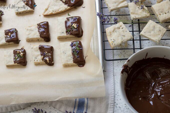 This Lavender Shortbread has fresh lavender, mint and lemon zest. Top with chopped nuts, like pecans, and dip in melted semi sweet chocolate, if you like. Welcome Summer with all it's fresh ingredients in this classic shortbread recipe. #lavender #mint #shortbread #freshlavender #lemon #lemonzest #pecans #cookies #chocolate #chocolatedipped
