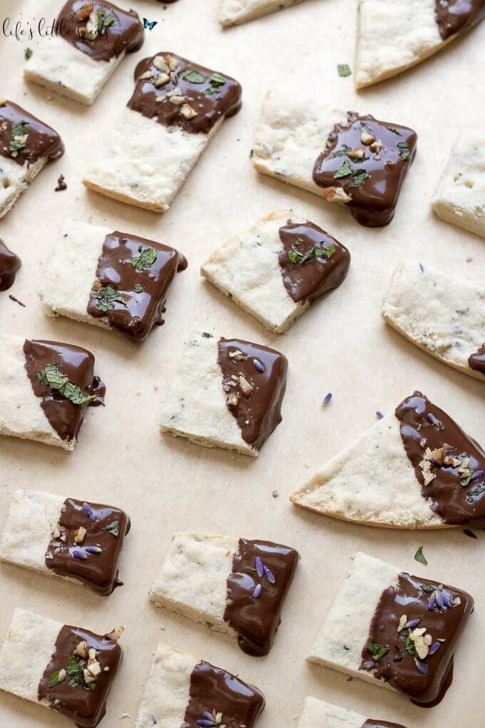 This Lavender Shortbread has fresh lavender, mint and lemon zest. Top with chopped nuts, like pecans, and dip in melted semi sweet chocolate, if you like. Welcome Summer with all it's fresh ingredients in this classic shortbread recipe. #lavender #mint #shortbread #freshlavender #lemon #lemonzest #pecans #cookies #chocolate #chocolatedipped