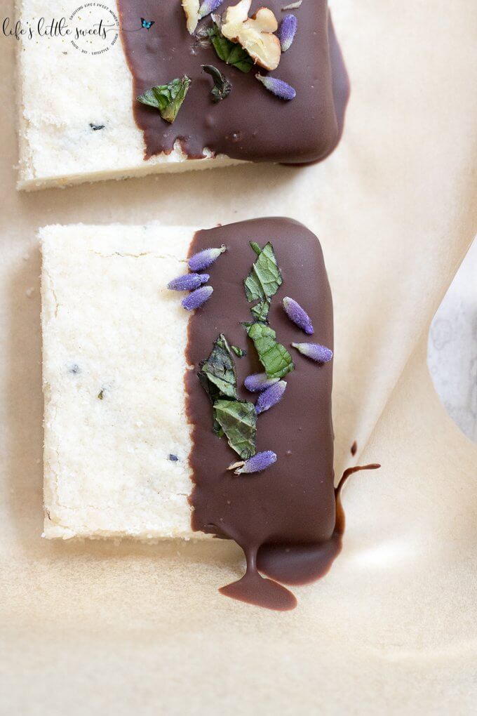 This Lavender Shortbread has fresh lavender, mint and lemon zest. Top with chopped nuts, like pecans, and dip in melted semi sweet chocolate, if you like. Welcome Summer with all it's fresh ingredients in this classic shortbread recipe. #lavender #mint #shortbread #freshlavender #lemon #lemonzest #pecans #cookies #chocolate #chocolatedipped