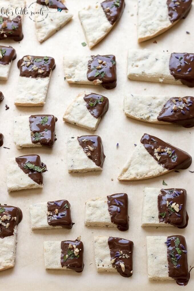 This Lavender Shortbread has fresh lavender, mint and lemon zest. Top with chopped nuts, like pecans, and dip in melted semi sweet chocolate, if you like. Welcome Summer with all it's fresh ingredients in this classic shortbread recipe. #lavender #mint #shortbread #freshlavender #lemon #lemonzest #pecans #cookies #chocolate #chocolatedipped