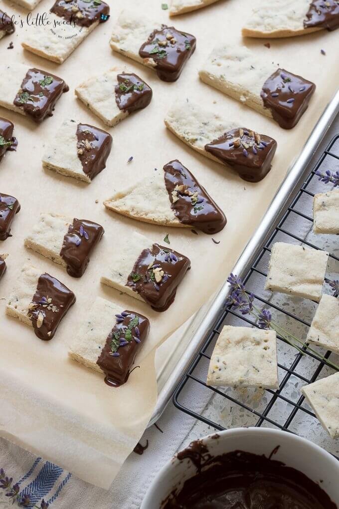 This Lavender Shortbread has fresh lavender, mint and lemon zest. Top with chopped nuts, like pecans, and dip in melted semi sweet chocolate, if you like. Welcome Summer with all it's fresh ingredients in this classic shortbread recipe. #lavender #mint #shortbread #freshlavender #lemon #lemonzest #pecans #cookies #chocolate #chocolatedipped