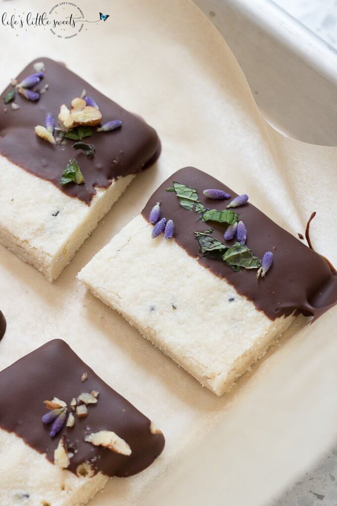 This Lavender Shortbread has fresh lavender, mint and lemon zest. Top with chopped nuts, like pecans, and dip in melted semi sweet chocolate, if you like. Welcome Summer with all it's fresh ingredients in this classic shortbread recipe. #lavender #mint #shortbread #freshlavender #lemon #lemonzest #pecans #cookies #chocolate #chocolatedipped