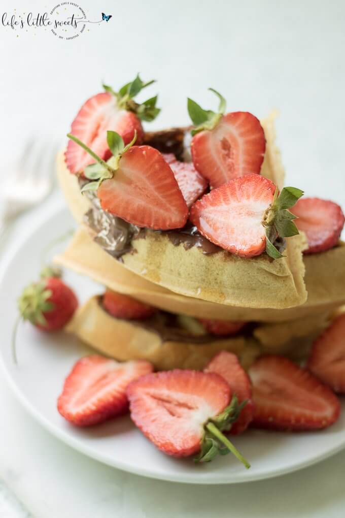 Having Strawberry Nutella Waffles is a sweet, chocolate-y and fresh way to start the day. Be it a weekday or family brunch, this pleasing combination of fresh strawberries, hazelnut-chocolate Nutella and maple syrup flavors with freshly made waffles is sure to please. #Nutella #strawberries #waffles #maplesyrup #breakfast