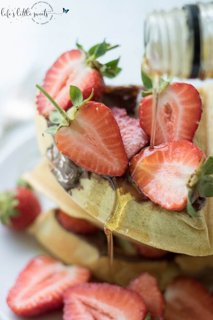 Having Strawberry Nutella Waffles is a sweet, chocolate-y and fresh way to start the day. Be it a weekday or family brunch, this pleasing combination of fresh strawberries, hazelnut-chocolate Nutella and maple syrup flavors with freshly made waffles is sure to please. #Nutella #strawberries #waffles #maplesyrup #breakfast