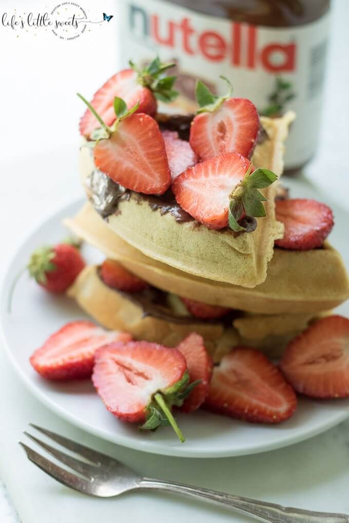 Having Strawberry Nutella Waffles is a sweet, chocolate-y and fresh way to start the day. Be it a weekday or family brunch, this pleasing combination of fresh strawberries, hazelnut-chocolate Nutella and maple syrup flavors with freshly made waffles is sure to please. #Nutella #strawberries #waffles #maplesyrup #breakfast