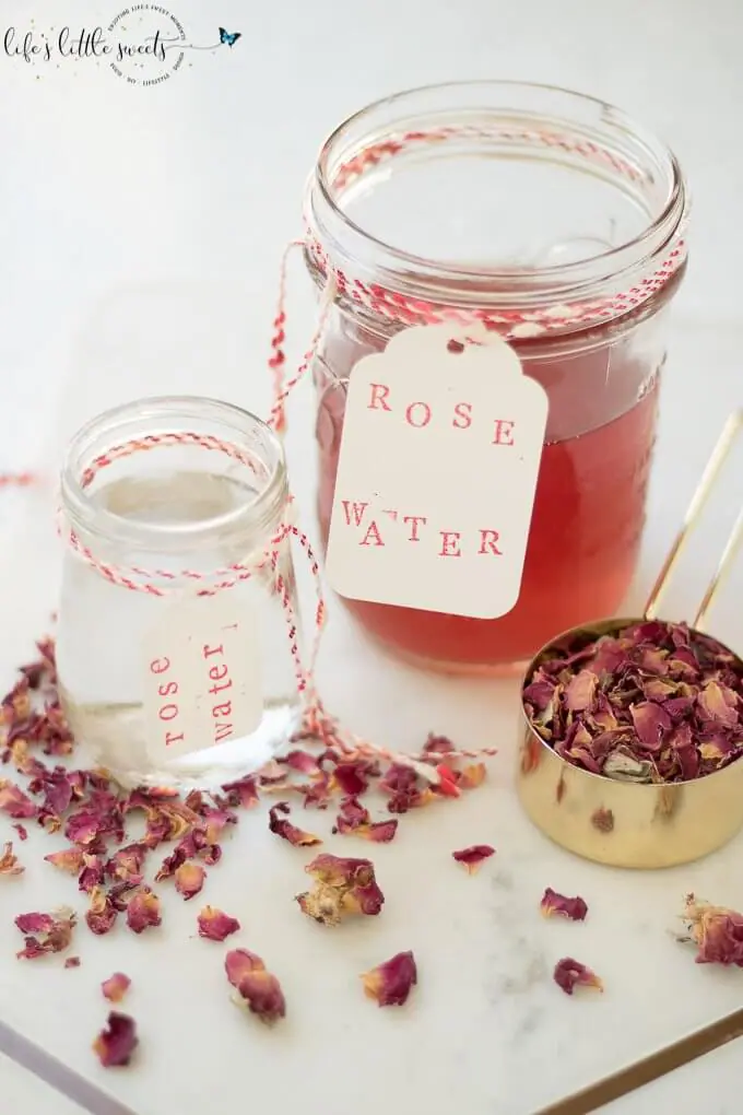 rose water in jars with labels and dried rose petals