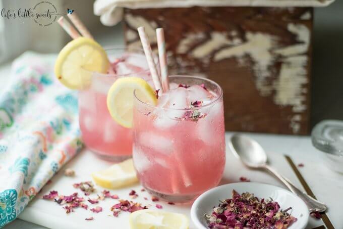 This Rosewater Lemonade is a thirst-quenching classic lemonade recipe with a fragrant and floral twist. Try this unique and beautiful lemonade for your next gathering! #rosewater #lemonade #drink #rose #roses #lemons #lemon #beverage #recipe #sweet