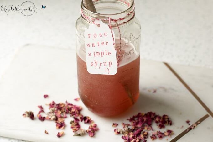 Rose Water Simple Syrup in mason jar with dried rose petals around it 