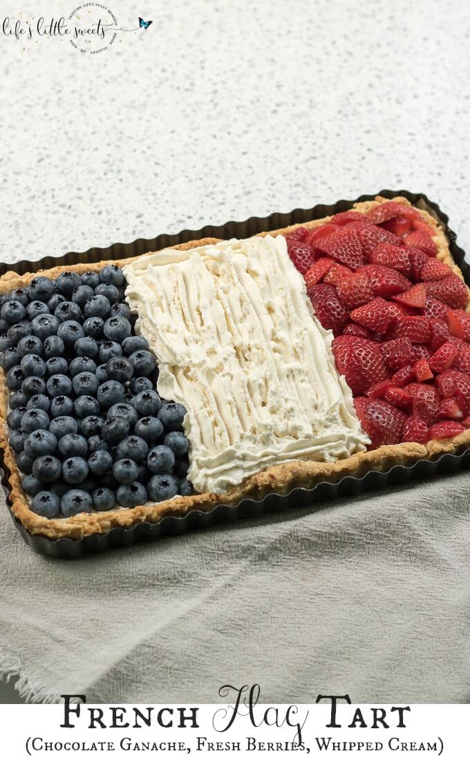 French Flag Tart has a homemade almond pie crust, a rich chocolate ganache filling, homemade, stabilized vanilla whipped cream and fresh, seasonal berries like strawberries and blueberries placed on top, in the symbol of the French Flag. #French #Frenchflagtart #tart #recipe #ganache #chocolate #espresso #coffee #berries #fruit #whippedcream #almond