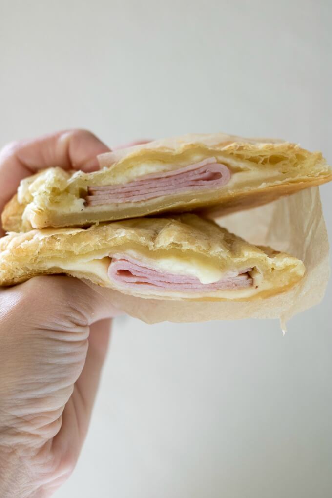 Cheesy Ham Puff Pastry Pockets on SoFabFood - These 3-ingredient Cheesy Ham Puff Pastry Pockets are perfect for easy school lunches or after-school snacks. These tasty hand pies are delicious hot or cold, your kids will love them, and they only take 20 minutes to make! #ad #sofabfood @sofabfood