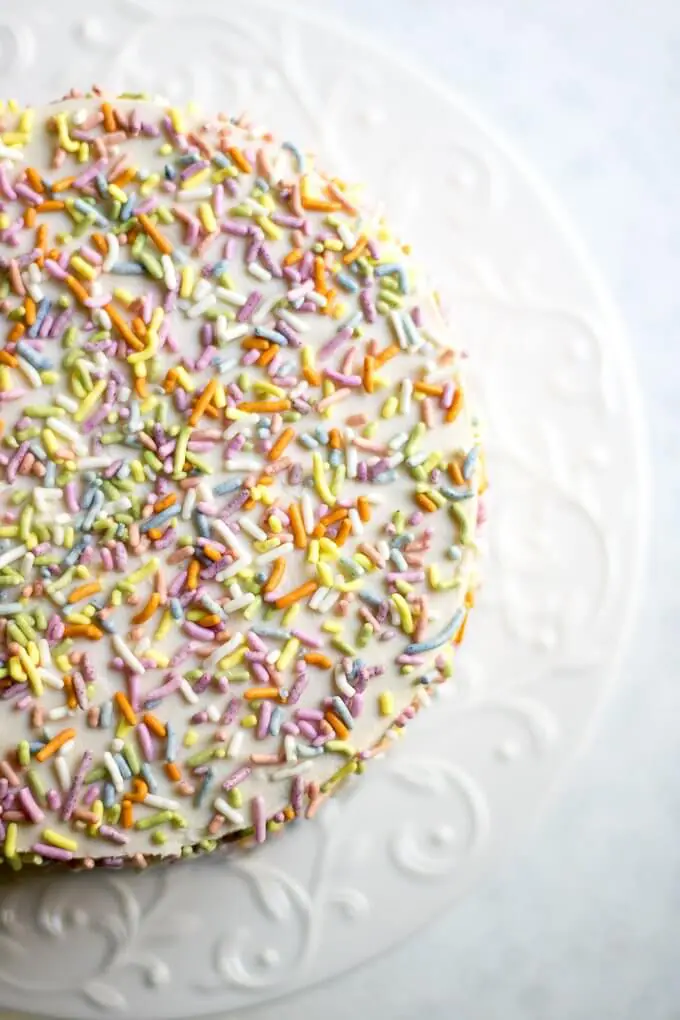 This 1st Birthday Cake recipe has 2 tiers, 5-inch diameter layers of delicious banana bread cake with a cream cheese frosting - all naturally-sweetened of course :) Top with all natural sprinkles for the cutest 1st Birthday cake ever! (gluten-free option) #cake #bananabread #1stbirthdaycake #naturallysweetened #maplesyrup #creamcheesefrosting #bananacake #birthdaycake #birthday #recipe