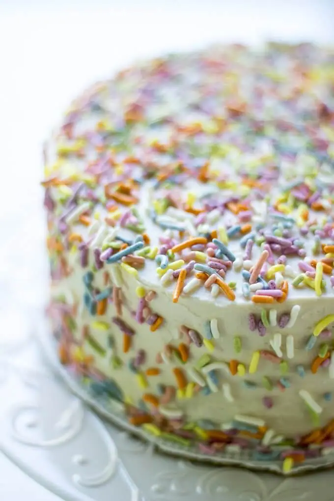 This 1st Birthday Cake recipe has 2 tiers, 5-inch diameter layers of delicious banana bread cake with a cream cheese frosting - all naturally-sweetened of course :) Top with all natural sprinkles for the cutest 1st Birthday cake ever! (gluten-free option) #cake #bananabread #1stbirthdaycake #naturallysweetened #maplesyrup #creamcheesefrosting #bananacake #birthdaycake #birthday #recipe