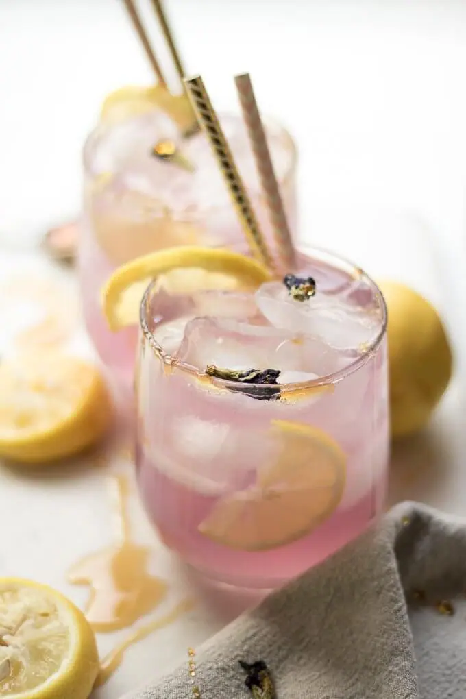 Blue Butterfly Pea Flower Lemonade is a sweet, tart and refreshing drink to level up your regular lemonade recipe. When making this recipe, as you add the lemon juice, it turns from an all natural dark blue to purple-pink thanks to the Blue Butterfly Pea Flowers. #peaflowers #lemonade #bluebutterflypeaflowers #drinks #iced #colddrinks 