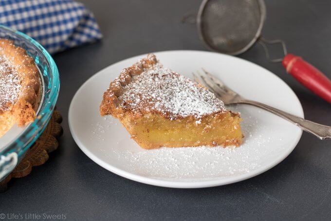 This Chess Pie recipe is a simple, solid, sweet pie recipe topped with confectioner's sugar, a sprinkling of crushed sea salt. It has a distinctive yellow batter which is thickened with corn meal. Bring to a holiday gathering, potluck or make it for an easy dessert after a weeknight meal. Serve it cold or warm and enjoy this delicious pie with a hot cup of coffee! (makes 1, 9-inch pie) #pie #chesspie #dessert #sweet #sugar #cornmeal #confectionerssugar