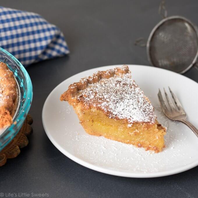 This Chess Pie recipe is a simple, solid, sweet pie recipe topped with confectioner's sugar, a sprinkling of crushed sea salt. It has a distinctive yellow batter which is thickened with corn meal. Bring to a holiday gathering, potluck or make it for an easy dessert after a weeknight meal. Serve it cold or warm and enjoy this delicious pie with a hot cup of coffee! (makes 1, 9-inch pie) #pie #chesspie #dessert #sweet #sugar #cornmeal #confectionerssugar