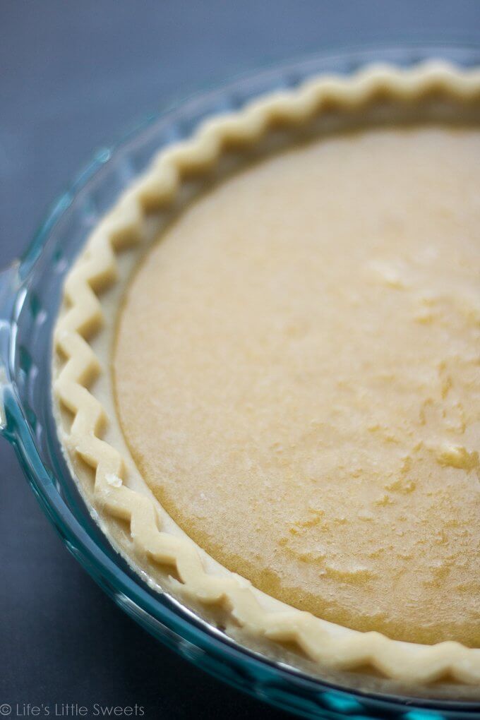 This Chess Pie recipe is a simple, solid, sweet pie recipe topped with confectioner's sugar, a sprinkling of crushed sea salt. It has a distinctive yellow batter which is thickened with corn meal. Bring to a holiday gathering, potluck or make it for an easy dessert after a weeknight meal. Serve it cold or warm and enjoy this delicious pie with a hot cup of coffee! (makes 1, 9-inch pie) #pie #chesspie #dessert #sweet #sugar #cornmeal #confectionerssugar