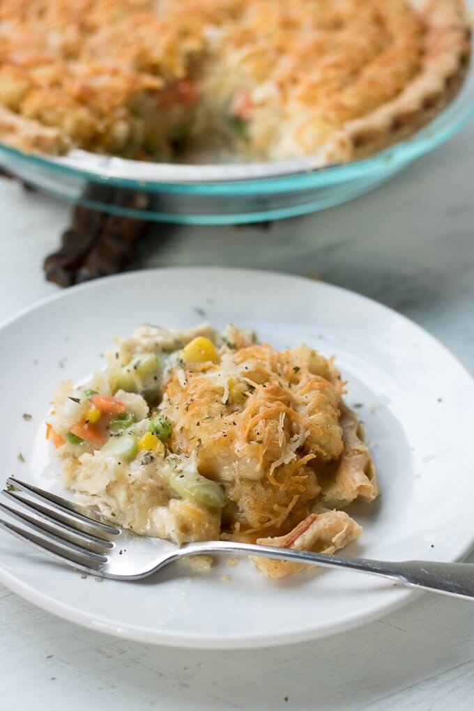 This Chicken Pot Pie Tater Tot Casserole Recipe is a savory and comforting one-dish recipe, perfect for dinner with your family or bringing to a gathering. It has chicken, pie crust, tater tots, mixed vegetables all combined into one lovely dish! (makes 2, 9-inch round casserole pies) #casserole #potpie #chicken #pie #savory #recipe #tatertot