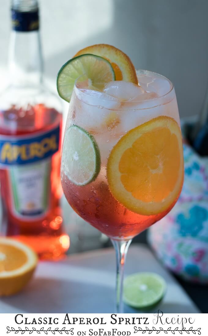 The Aperol Spritz is making a comeback for a reason! This Italian classic cocktail consists of Aperol, Proscecco, orange and lime slices, and club soda. Perfect for dinner parties or happy hour, the vibrant color and flavors add to the joy of any occasion! #ad @sofabfood #sofabfood