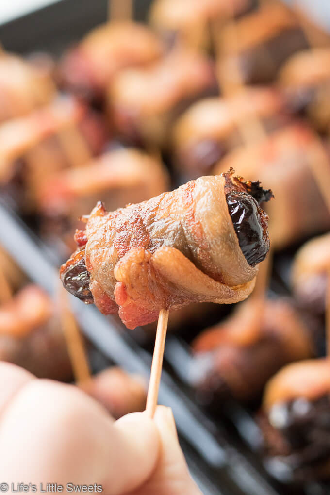 Bacon Wrapped Stuffed Dates are a savory-sweet appetizer or snack, served hot, perfect for having at a gathering. Pitted Medjool dates stuffed with soft cheese like Blue or Stilton Cheese, then wrapped with thick-sliced bacon and baked on a cast iron grill pan (or rimmed baking sheet). They are so delicious and mouthwatering that you can never have just one! #bacon #recipe #dates #Stilton #stuffeddates #hotappetizers #appetizers #gameday #Christmasfood #christmas