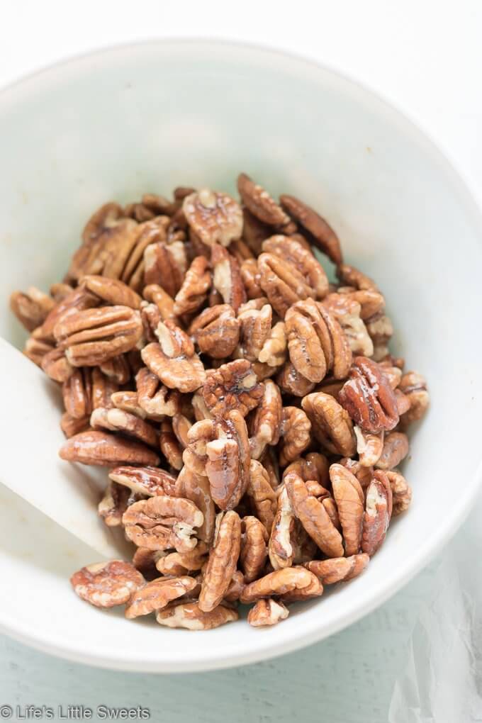 Candied Pecans are a spiced, salty-sweet snack perfect for an edible gift! They are easy to make and easily customizable to your tastes. My version has halved pecans, cinnamon, regular & brown sugar, maple syrup, pure vanilla extract, a little bit of ground nutmeg and Harrissa seasoning.  #pecans #ediblegifts #candiedpecans #harissa #cinnamon #snacks #recipe #brownsugar #maplesyrup