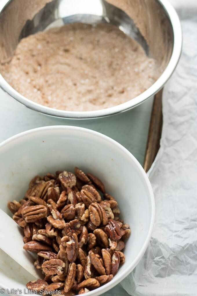 Candied Pecans are a spiced, salty-sweet snack perfect for an edible gift! They are easy to make and easily customizable to your tastes. My version has halved pecans, cinnamon, regular & brown sugar, maple syrup, pure vanilla extract, a little bit of ground nutmeg and Harrissa seasoning.  #pecans #ediblegifts #candiedpecans #harissa #cinnamon #snacks #recipe #brownsugar #maplesyrup