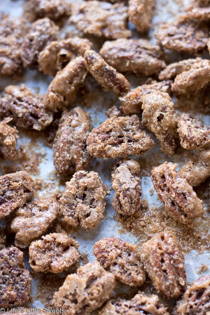 Candied Pecans are a spiced, salty-sweet snack perfect for an edible gift! They are easy to make and easily customizable to your tastes. My version has halved pecans, cinnamon, regular & brown sugar, maple syrup, pure vanilla extract, a little bit of ground nutmeg and Harrissa seasoning.  #pecans #ediblegifts #candiedpecans #harissa #cinnamon #snacks #recipe #brownsugar #maplesyrup