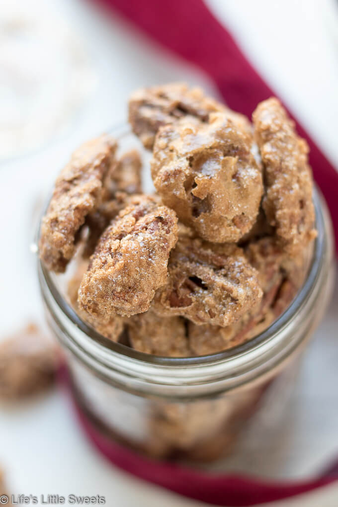 Candied Pecans are a spiced, salty-sweet snack perfect for an edible gift! They are easy to make and easily customizable to your tastes. My version has halved pecans, cinnamon, regular & brown sugar, maple syrup, pure vanilla extract, a little bit of ground nutmeg and Harrissa seasoning.  #pecans #ediblegifts #candiedpecans #harissa #cinnamon #snacks #recipe #brownsugar #maplesyrup