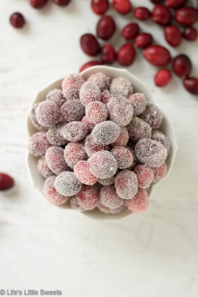 Sugared Cranberries are sweet, tart and are wonderful as garnishes on cocktails, on appetizer boards or to top desserts. They add a bright, red and festive flair to any table - plus they are easy to make with only 2 required ingredients on the stove top! #sugaredcranberries #cranberries #sugar #sweet #tart #garnish #Winterfood #appetizer #brownsugar