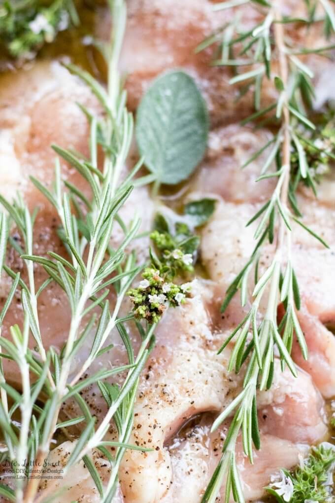 raw chicken thighs with fresh herbs and marinade close up