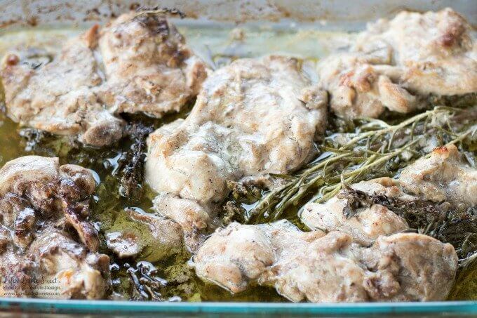 Balsamic Herb Baked Chicken Thighs in a glass baking dish