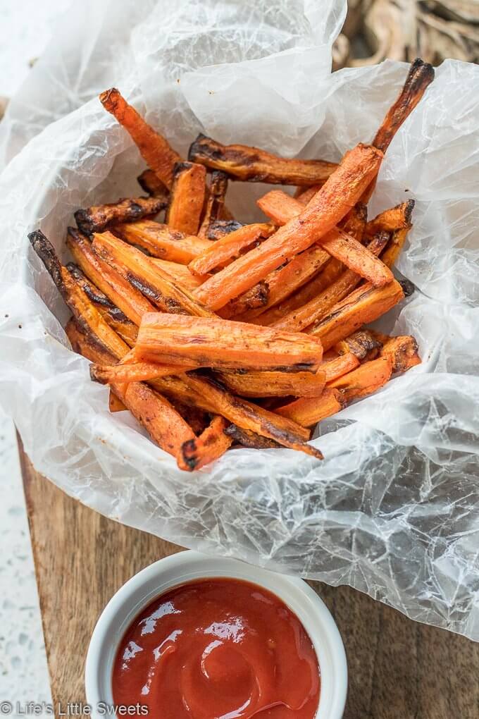 Air Fryer Carrot Fries have ground cumin, smoked paprika, kosher salt and fresh ground pepper with a small amount of Canola oil. This is a more healthy version of carrot fries with less oil using an Air Fryer. This easy recipe only requires 7 ingredients and 15 minutes! (gluten free, vegan) #ad #carrots #carrot #fries #airfried #airfryer #easy #airfryercarrotfries #savory #recipe #cumin #paprika #salt #pepper