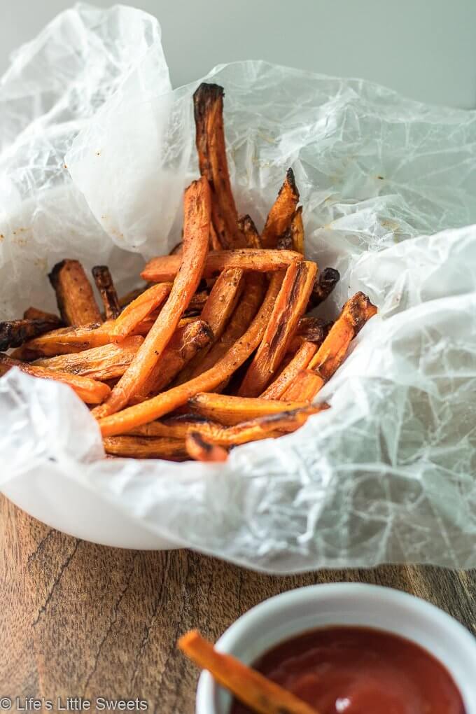 Air Fryer Carrot Fries have ground cumin, smoked paprika, kosher salt and fresh ground pepper with a small amount of Canola oil. This is a more healthy version of carrot fries with less oil using an Air Fryer. This easy recipe only requires 7 ingredients and 15 minutes! (gluten free, vegan) #ad #carrots #carrot #fries #airfried #airfryer #easy #airfryercarrotfries #savory #recipe #cumin #paprika #salt #pepper
