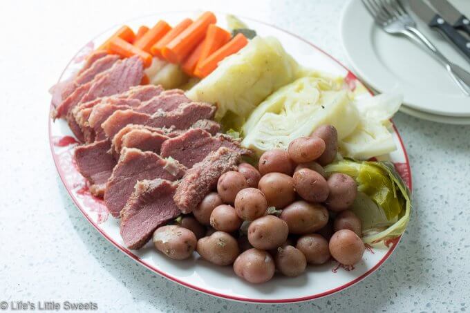 Corned Beef and Cabbage is a classic Irish-American family dinner popular to serve on St. Patrick's Day. This savory, delicious and complete meal is cooked in a Dutch Oven on the stove top with corned beef brisket, baby red potatoes, green cabbage wedges and carrots. #cornedbeefandcabbage #stpatricksday #carrots #redpotatoes #recipe #greencabbage #cabbage #Dutchoven #brisket