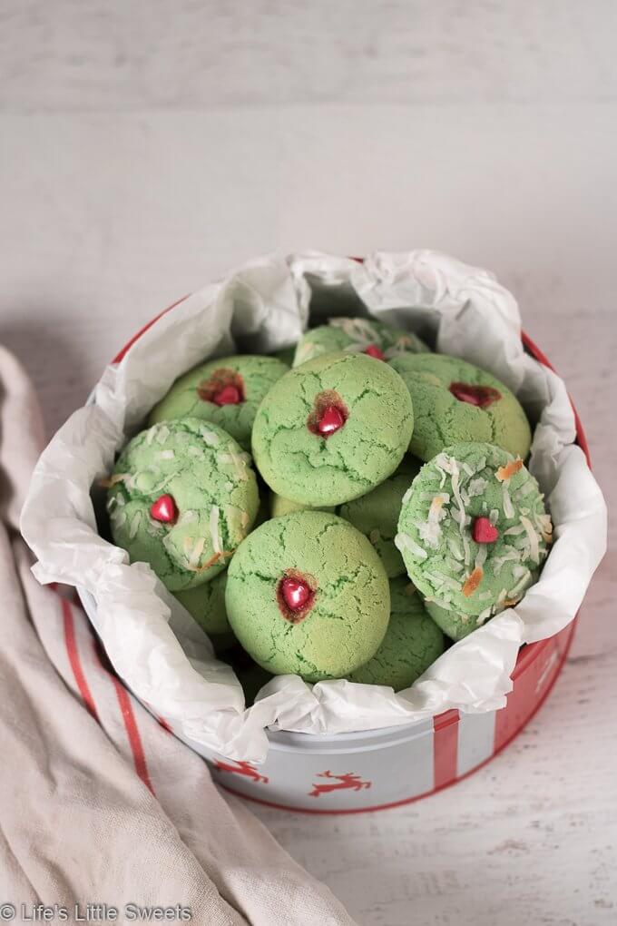 Grinch Sugar Cookies are classic sugar cookies, tinted green with a red candy heart in the middle. These delicious cookies are inspired by the beloved children's book and movies, The Grinch. enjoy these easy, fun, homemade, cookies during the holidays or throughout the year!  #grinchcookies #cookies #thegrinch #grinchfood #dessert #sweets #thegrinchmovie #sugarcookies #grinchsugarcookies